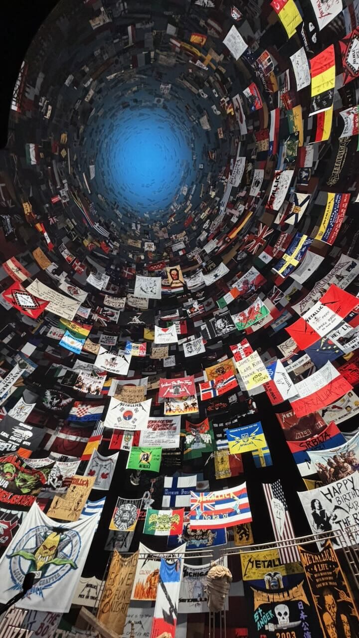 Looking straight up into the Sphere, with fan club flags covering the screen like a tunnel